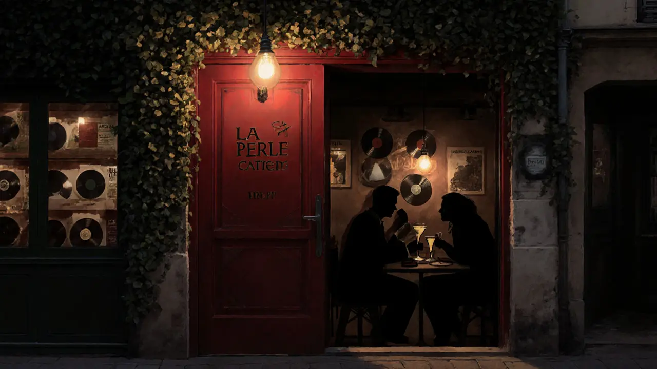 A hidden red door at La Perle glows warmly above a quiet bakery at night.